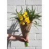 bunch of daffodils wrapped in brown paper